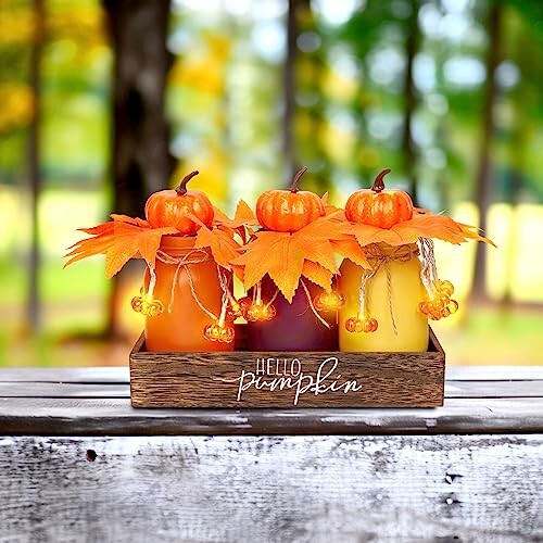 Decorative jars with pumpkins and autumn leaves on a wooden tray, showcasing the product's rustic charm.