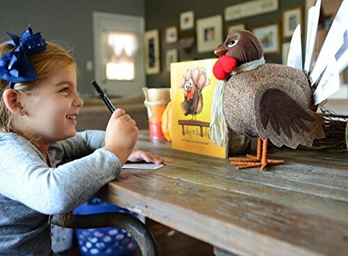 Child smiling while writing at a table with a Thanksgiving turkey decoration.