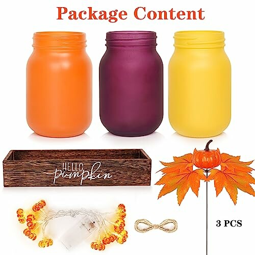 Three colorful mason jars with fall decor items including leaves, lights, and a wooden tray, showcasing a beautifully styled fall centerpiece.