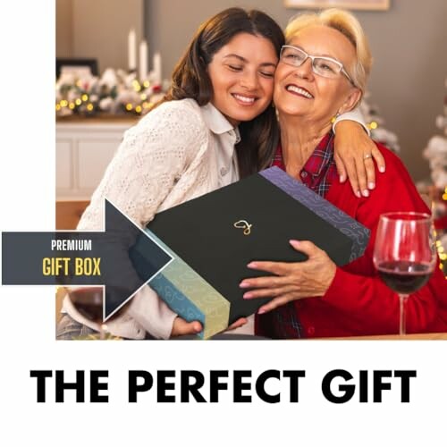 Woman hugging elderly lady holding a gift box