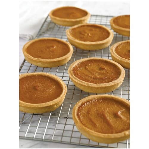 Small pumpkin pie tarts on a cooling rack.