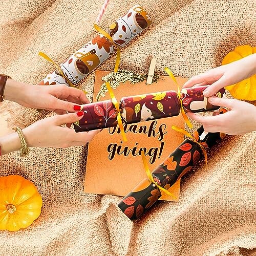 Hands holding festive Thanksgiving crackers over a decorative background.