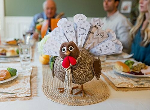 Thanksgiving table with turkey centerpiece and people seated.