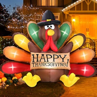 Inflatable Thanksgiving turkey decoration with a 'Happy Thanksgiving' banner.